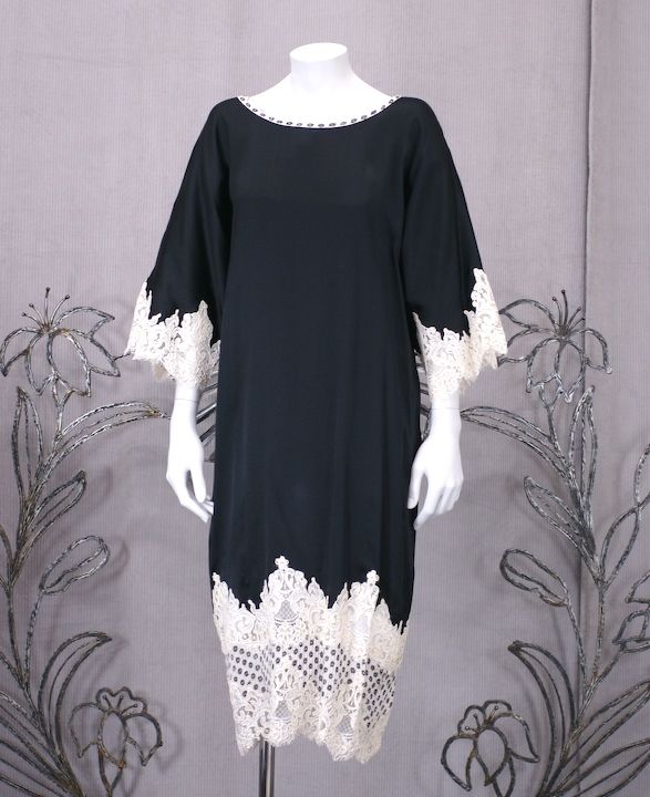 Geoffrey Beene's chic T shirt dress made in the most luxurious fabrications. Deep navy silk jacquard crepe is trimmed with a black and white plisse floral and wide white panels of peek a boo lace. Effortless and timeless dressing from an important