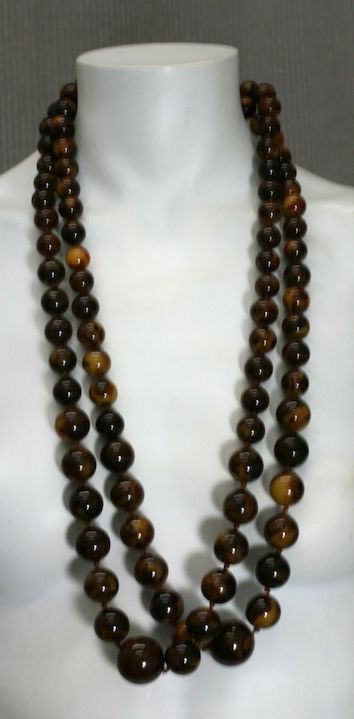 Double strands of marbleized (brown to caramel), graduated Bakelite Beads from the 1960's. Hand knotted and very versatile. 36