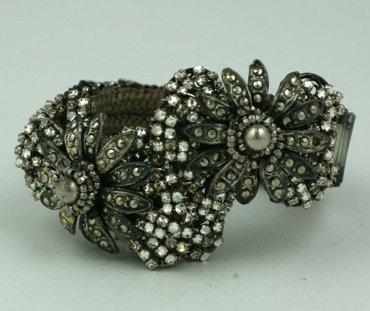 Miriam Haskell early wrap bracelet from the 1930s. Marcasites, pastes and seed beads are stitched unto an expandable tension bracelet that fits all sizes. Elaborate floriform design, typically Haskell.  Extremely ornate construction. These early