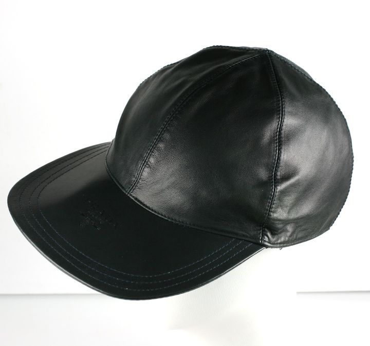 Beautiful quality calfskin leather baseball cap with oversized brim by Miuccia Prada. Deep navy eggplant leather (not black) with logo embossed on large brim.<br />
Adjustable with back buckle:22-24