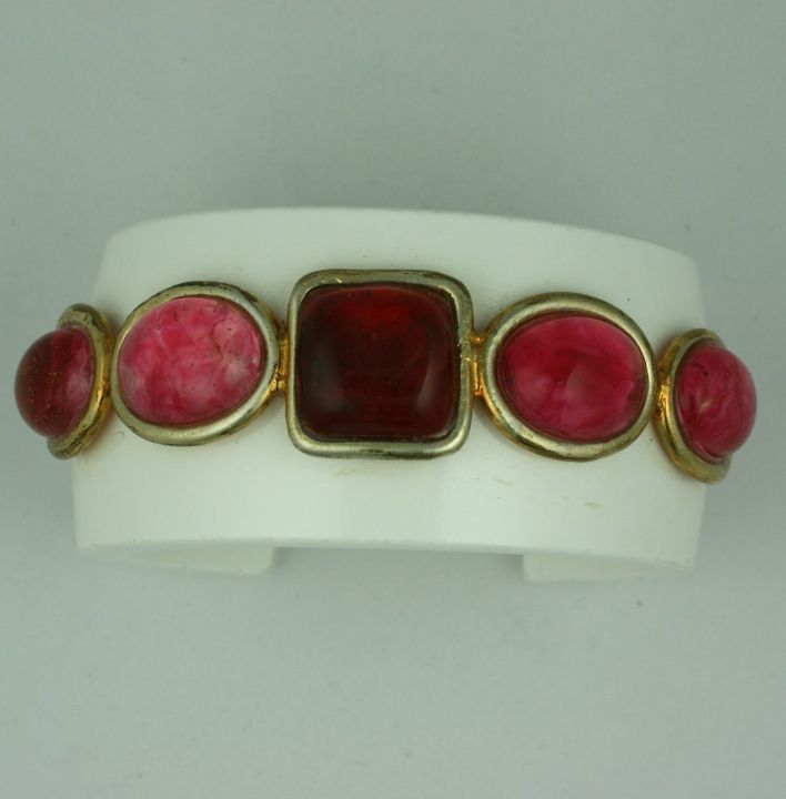 Chanel bakelite cuff with Gripoix ruby poured glass cabochons. <br />
1980s France.<br />
Signed: Chanel<br />
1.75