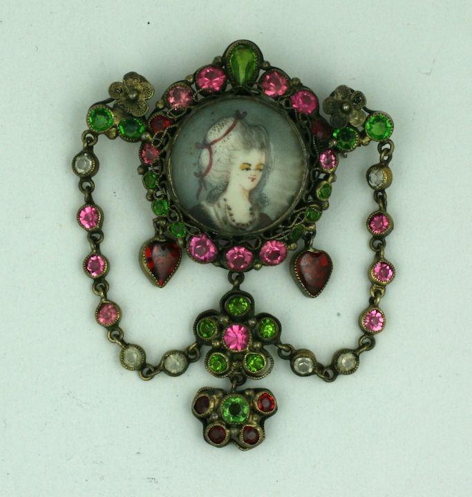 In the height of the Art Deco era, Hobe jewels manufactured jewels in an older,sweeter style. Completely handmade with colored crystals and a hand painted maiden portraiture, this brooch veered much more toward the Victorian era, 30 years earlier.