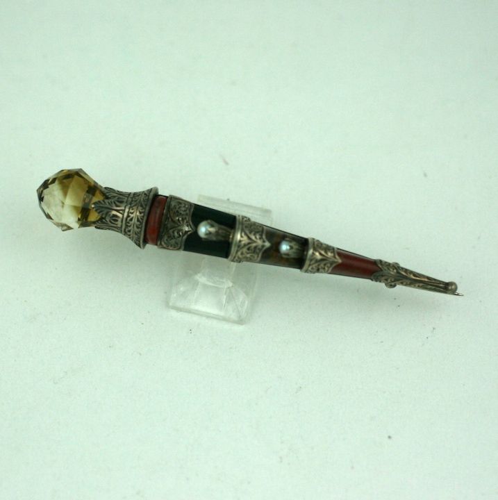 Attractive Scottish dirk brooch of mixed agates, marble and pearls with a facetted smokey quartz thistle cap. Late 19th Century with wonderful hand etched detailing. Set in Sterling silver.<br />
3.25