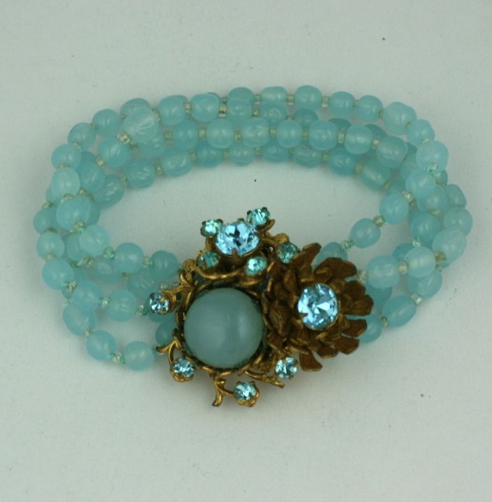 Miriam Haskell 4 strand aquamarine poured glass bead bracelet. Manipulated clasp with gilt metal flowers and aquamarine swarovski crystals. 1950s USA.<br />
7.5" x 1", clasp 1.25"<br />
Excellent condition