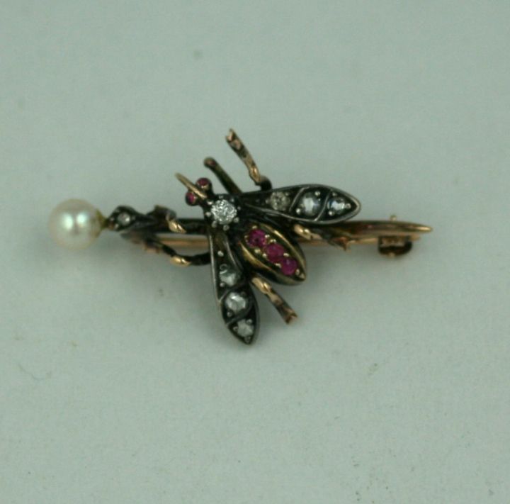 Late 19th Century rose diamond and ruby bee set on a pearl capped staff. Charming subject matter typical of Victorian novelties.<br />
Excellent condition.