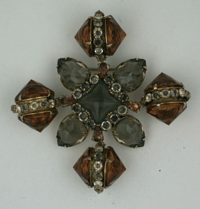 Amazing Schreiner crest of topaz and smoke colored crystals. Unusually set with stones pointed outward for dimension and interest. Clear crystal accents trhoughout. USA 1950s. Unsigned. 3.25