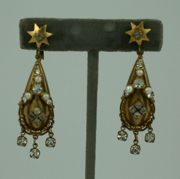 Unusual neo-Victorian style earrings attributed to Joseff of Hollywood. Clip backs with pastes, faux pearls and dangles. Made in 3D in the antique gold finish that was used primarily by Joseff. 2.5