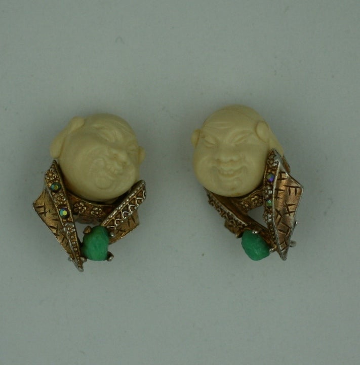 Collectible Har earrings of asian men in gilt settings with faux jade stones and aurora borealis crystals. Clip back fittings. 1950s USA.<br />
Excellent condition.