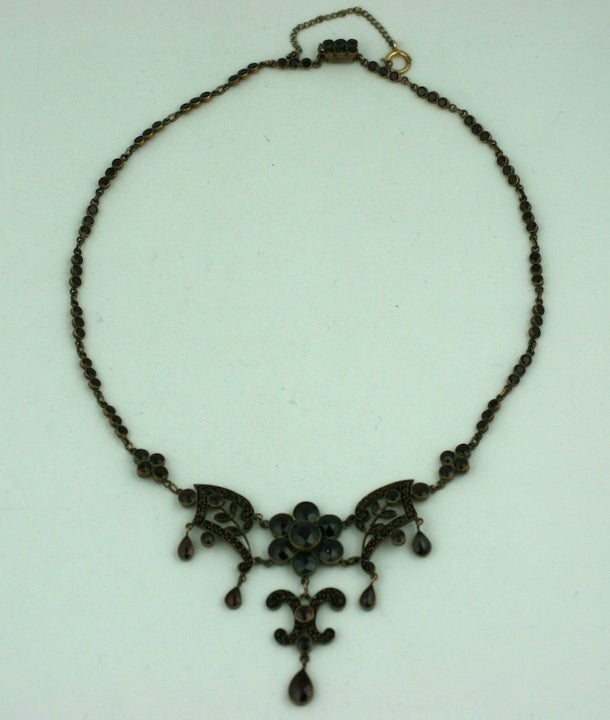 Attractive garnet set necklace with articulated fern patterned links and drops. Larger stones and drops have rose cut stones.  The links are bezel set with tiny garnets as well.
Late 19th Century, Excellent condition.