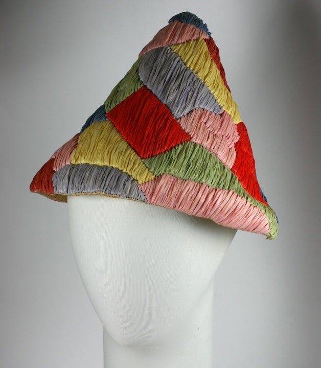 Italian harlequin patterned multicolor summer resort hat. Hand made of rafia and straw of conical form, Italy 1950s. Excellent condition.
Edge 27