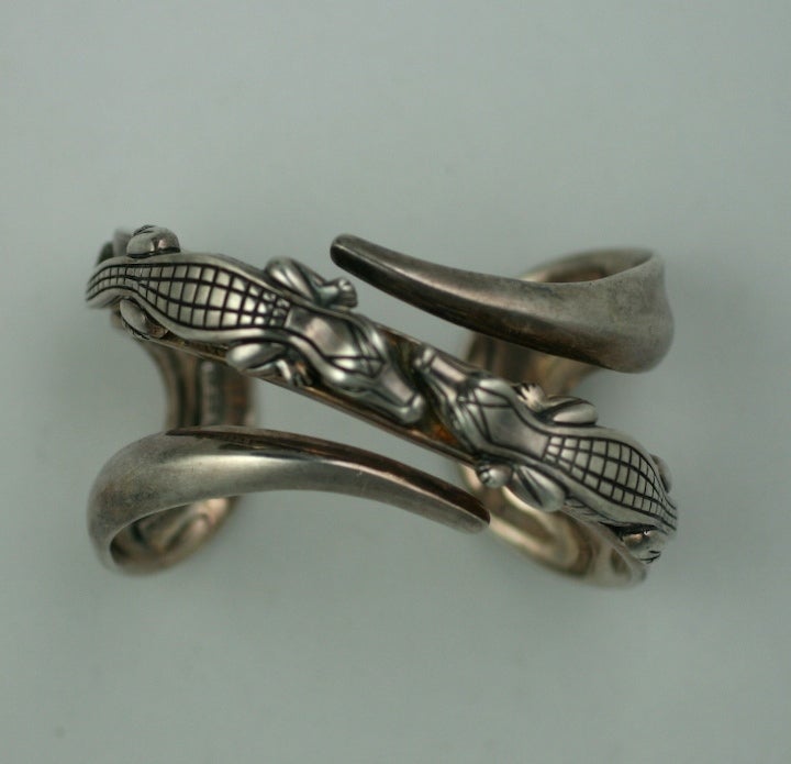 Attractive dueling alligator cuff by Barry Keiselstein Cord. Cast in heavy sterling with beautiful detailing and construction. Diamond accented eyes on both.Designed to look like they are entwined around your wrist. Excellent condition. 1.75