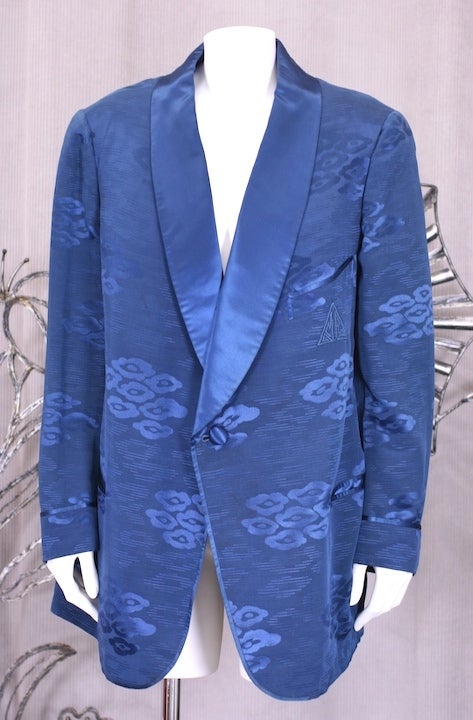 Deep royal blue silk smoking jacket in an asian cloud pattern. Completely lined in royal blue silk satin. Beautifully tailored with satin shawl collar and piping by Sulka, NY.Mens Size: Large. 
Excellent condition with original monogram 