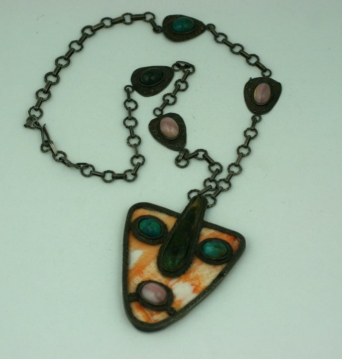 Artisan handmade pink abalone shell and vari colored agate cabochons form this modernist style mask pendant,set in patinaed silvertoned metal. 1950's. 
Excellent condition.