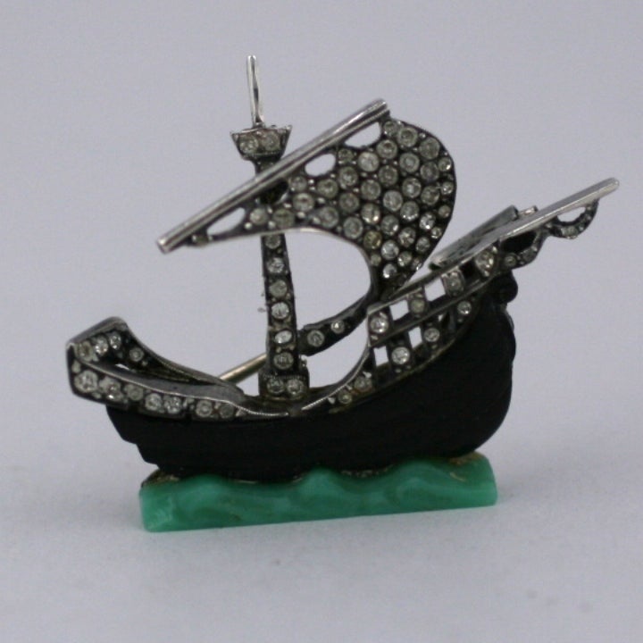 Charming galleon brooch of pastes set in sterling with a carved black bakelite body and jade bakelite waves. Lovely with exceptional quality and detailing.  1.5