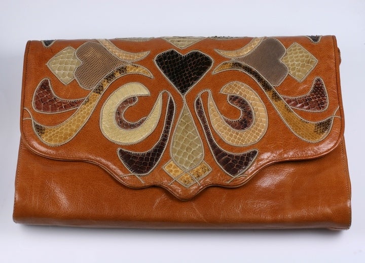 Large pieced clutch of vari skins of snake, calf and lizard in an art nouveau 80s rehash with retractable strap. Excellent condition, made by Sharif, NY. 1980's USA.
13