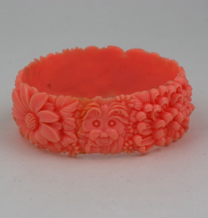Adorable celluloid bangle from the 1930s with high relief molded flowers, a terrier and an elephant. Japan 1930s. 1