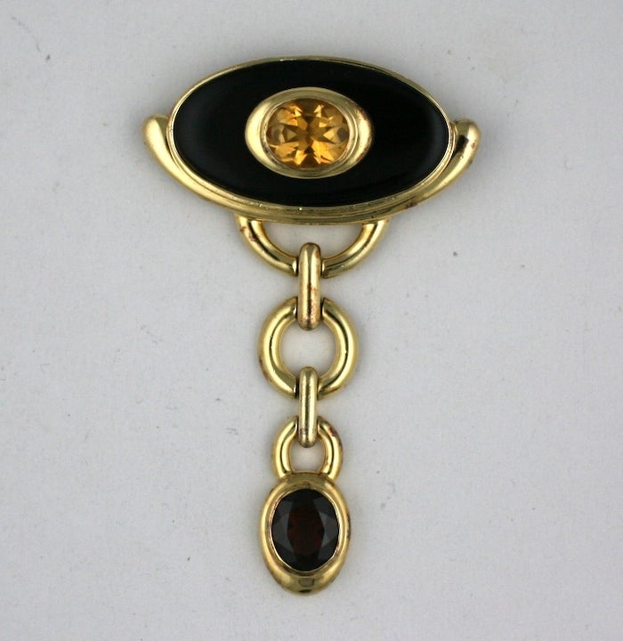 Attractive deco inspired brooch by Kai Yin Lo in gilt sterling with onyx, garnet and citrine. She had boutiques in the finest stores such as Bergdorf Goodman throughout the 1980's.
Has retractable loop for pendant. 3