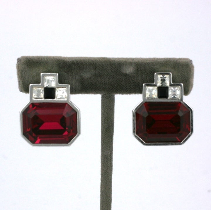 Attractive Swarovski ruby paste earclips by YSL with accents in crystal and onyx. Clip back fittings. 1980's France. 1 1/8 x 7/8