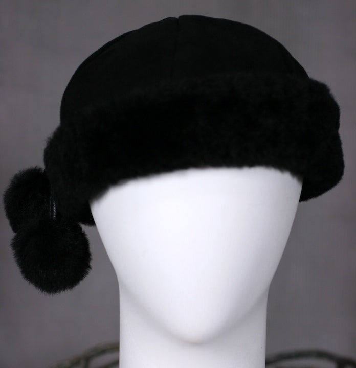 Attractive black shearling cap with 2 shearling pom poms by Burberry UK.
Excellent condition.
26.5