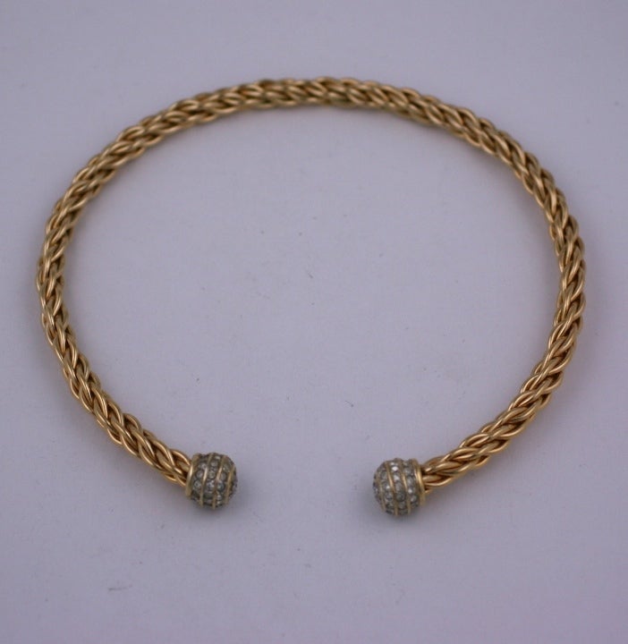 Gilt twisted wire torque collar with pave ball hilts from the 1980s.
15