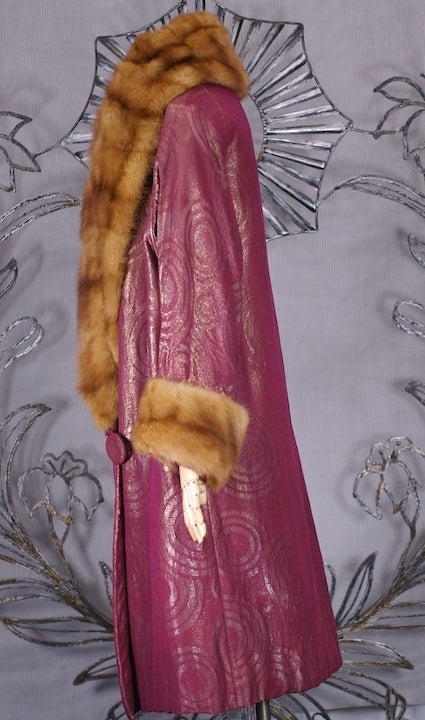 1920's lame broche gold and port opera coat .The fabric woven with  art deco concentric circles and center dots. Trimmed with full natural Japanese mink shawl color and cuffs.
Smaller size 4-6-8.
Overarm measure 29