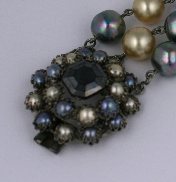 Rare bracelet by Countess Cis composed of three strands of large iridescent grey and cream Signature handmade Cis faux pearls.The large clasp of smaller pearls in signature claw settings,with center square cut hematite square stone set in darkened