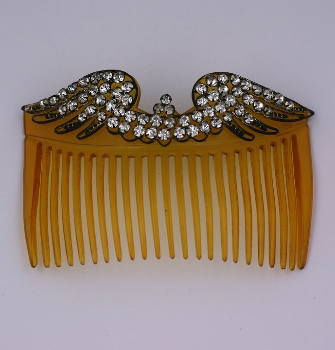 Edwardian faux tortoise celluloid large hair comb, mounted with paste set silver gilt bird wings. Made in France circa 1900.
5