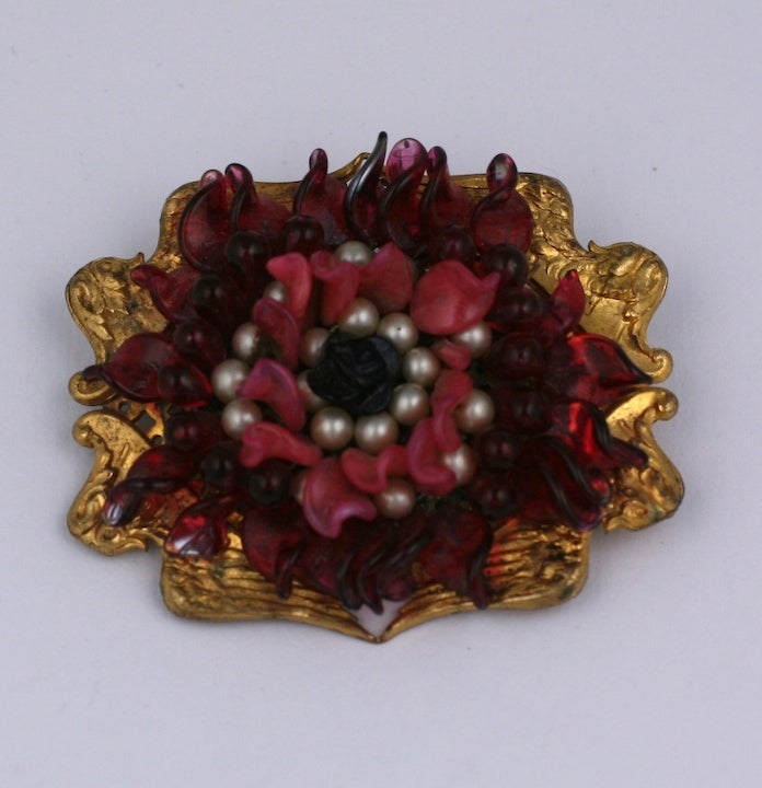Louis Rousselet handmade ruby,pink coral and faux pearl flower form pate de verre brooch in a setting of gilt metal wings.
1930s France. Excellent condition.  2.5