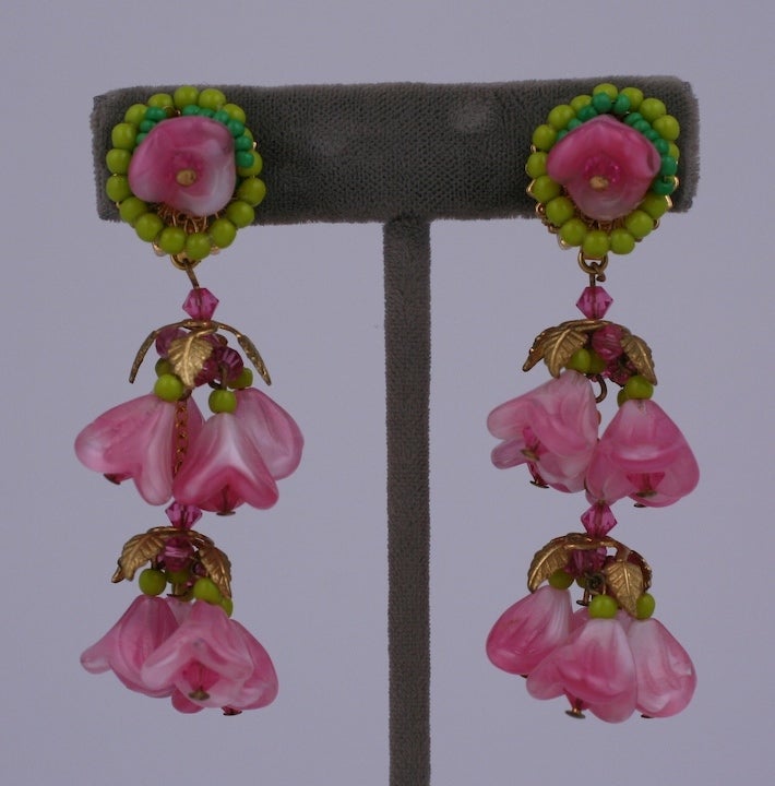 Colorful pate de verre bellflower dangle earrings in lime and rose glass with gilt metal leaf caps and rose crystals.
Unsigned Amourelle. USA 1940's. 
2 5/8
