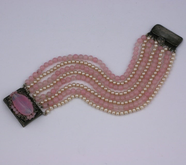 A rare example of a wide bead bracelet by french costume jeweler Louis Rousselet composed of shades of rose pate de verre glass handmade beads and signature faux pearls. 1930s France. Excellent condition.

7.5