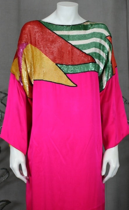 Wonderfully colorful Sequined and Satin T Shirt Evening Gown. Bright fuschia silk satin lined in chrome yellow with sequin panels across chest and shoulders. Easy T shirt fit with deep kimono sleeves with high slit on back.  1980's USA. 
Unsigned