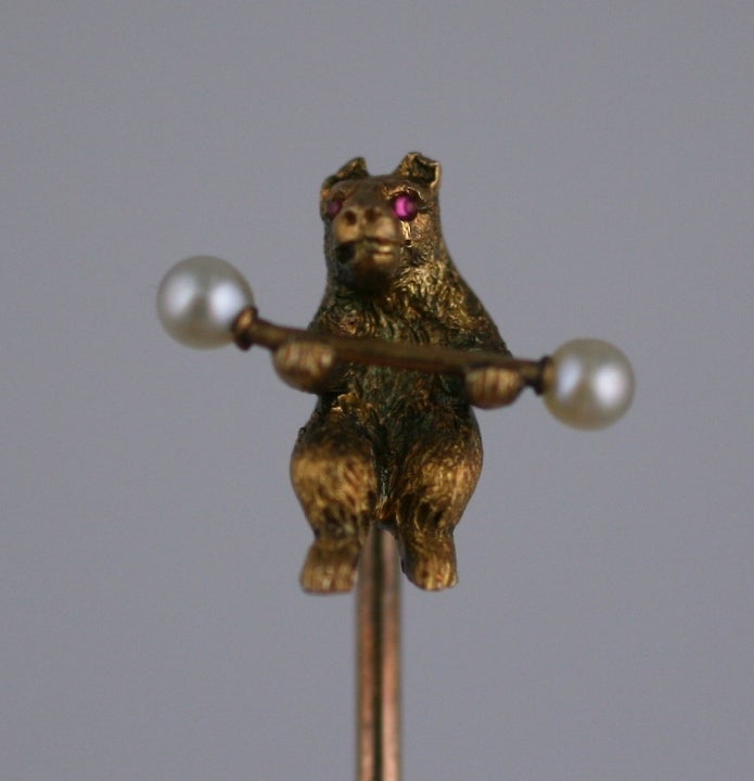 Charming circus bear, grimacing under the weight of his natural pearl barbell. Unusual and amazing figural charmer from the late 19th Century. Gold with ruby eyes and natural pearls. Timeless jewels such as this incorporate quality, design and