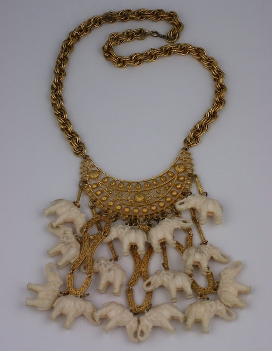 Bib comprised of a dozen faux ivory elephants on an etruscan work gilt metal linked bib. Large in scale and caftan ready.
18