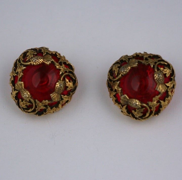 Dimensional Florenza earrings of faceted red lucite caught within a openwork frame of gilded thistles. Striking in size, 1960's USA.
Excellent condition.
1.25