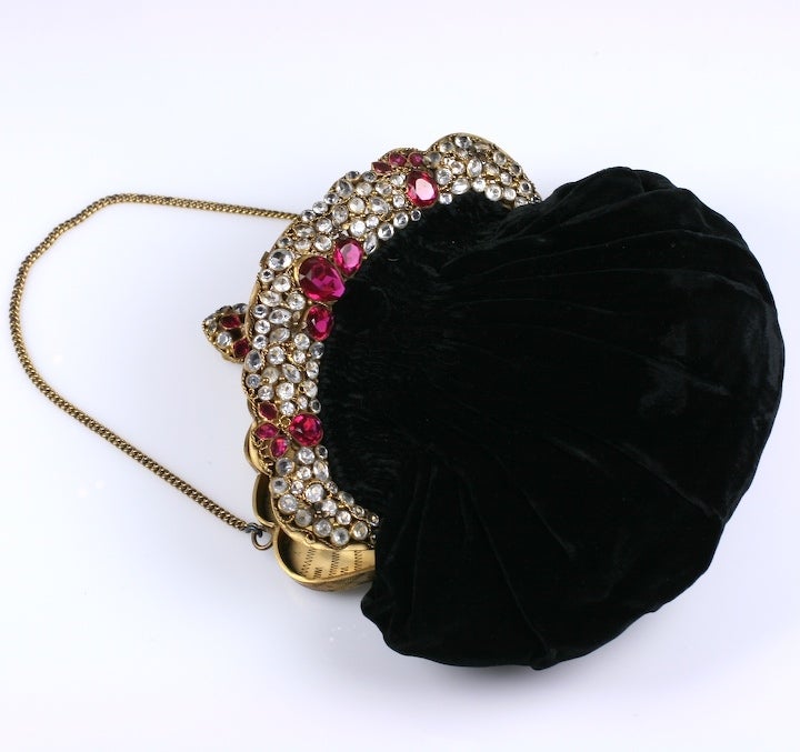 Hobe Gem Encrusted Evening Bag with faux rubies and diamonds, hand set into an enormous gilt filigreed frame. Wonderful quality with black silk velvet pouch and gilt chain. 1940's USA. 
Unsigned. 6