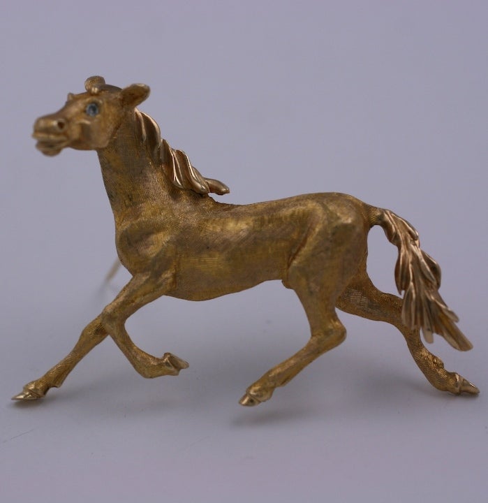 Attractive horse in full gallop with diamond eye accents. Heavy cast 14K gold with textured details. Beautiful quality. 1950's USA.
2.25