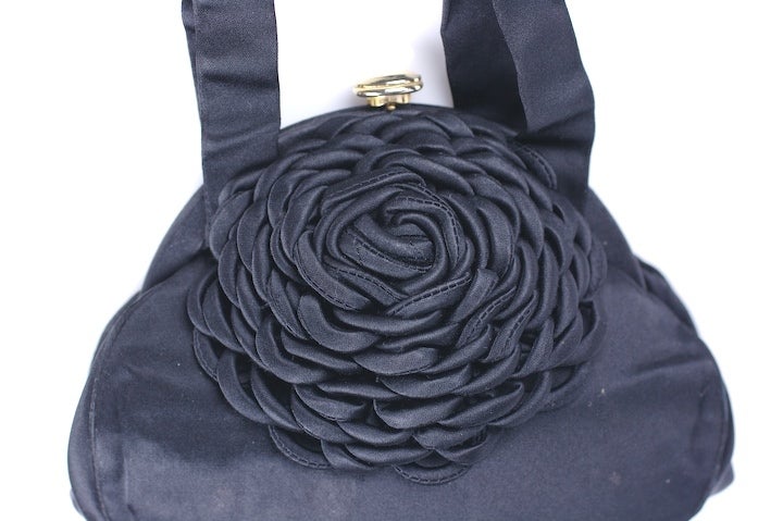 Charming satin evening bag with applied motif made of dozens of loops of bias satin to form an oversized flowerhead near clasp. Push button clasp. 1940's USA. 8