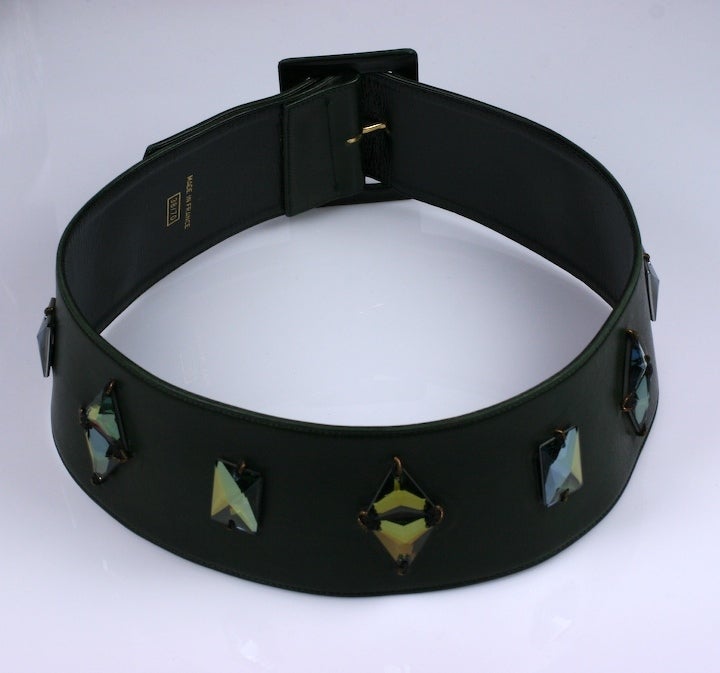 Deep olive calf belt from the late 1980's with leather self covered buckle and aurora Swarovski triangular crystals applied. Belt is cut on the round so it molds to waist and upper hip slightly. Adjustable from 26.5