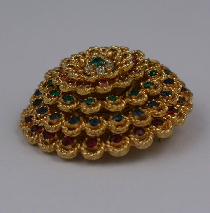 Marcel Boucher's elegant gilt flower brooch of rope design studded with tiers of colored pave rhinestones. 1960's USA. Excellent condition.  1.75