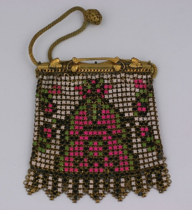 Charming childs purse of metal mesh enamelled in deco patterns. Unusual closure with cottton cord drawstring. Ormolu leaf decorated frame.
1930s USA.  2.5