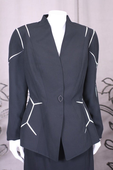 Classic Mugler beautifully cut power suit in navy faille with white inserts forming a honeycomb pattern throughout. Snap front closure with slim cut skirt. France 1990s. Size 42. The 