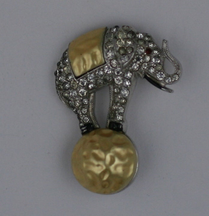 Small yet charming, this early Trifari brooch depicts an Art Deco circus elephant performing on a 