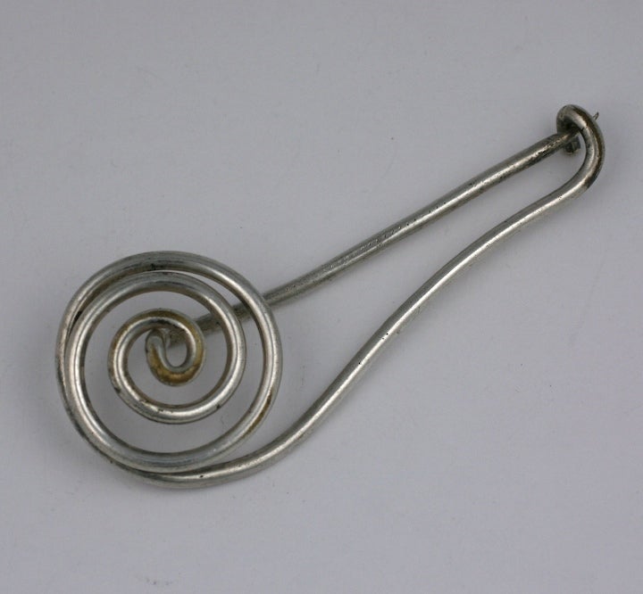 French coiled brooch fashioned as a modified kilt pin in silvered metal, marked MADE IN FRANCE. 1960's France.
Excellent condition.
3.75 x 1.5