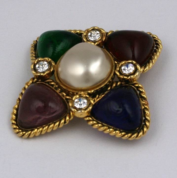 Chanel multicolored poured glass brooch in tones of ruby, emerald, sapphire and amythest highlighed with pastes and a central faux pearl. Made by Maison Gripoix. 2.5