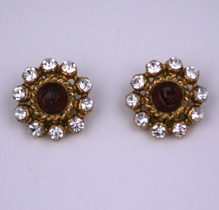 Chanel earclips by Maison Gripoix with poured ruby glass centers and swarovski crystal accents. Set in gilt metal, 1980s France. Excellent condition.