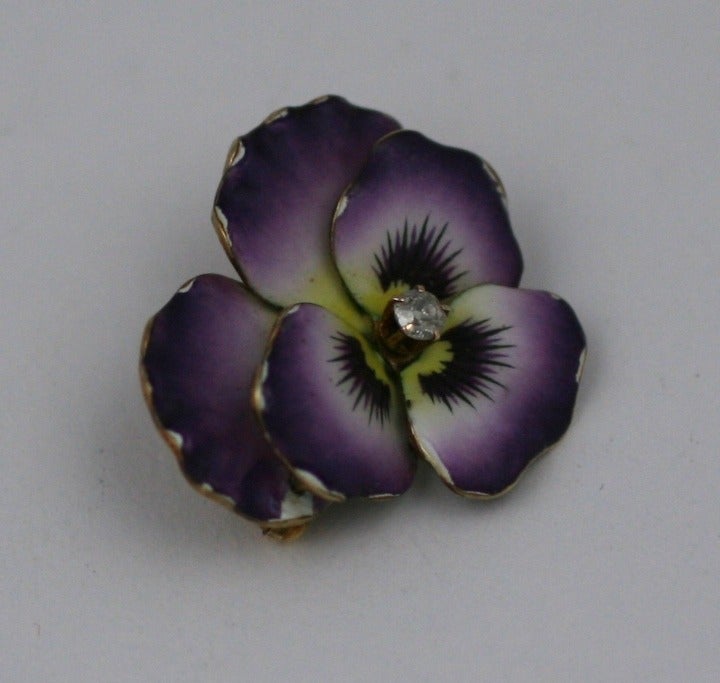 Enamelled Pansy brooch set in 14K gold from the late 19th Century. The enamel is not perfect. There are slight edge chips along the petals and a larger chip on one of the under petals which isnt visible when worn.
Attached swivel pendant fitting so