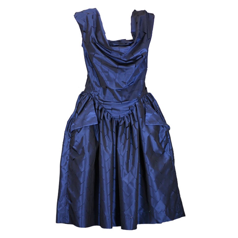 Prom dress meets Edward Scissorhands in Vivienne Westwoods sweetly subversive rendition in deep navy laser cut taffeta.  Can be worn off the shoulder or up. Size 44 Italian. 
Waist is 28