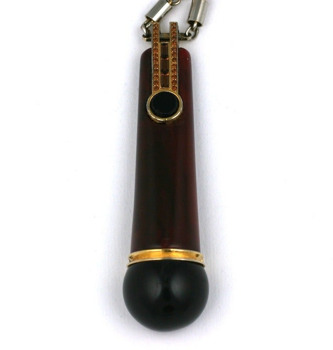 Givenchy jeweled toggle pendant in 2 tones of bakelite (maroon and jet) with rhinestone accents set on a silvered tube link chain. 1970s France. Toggle: 3.5