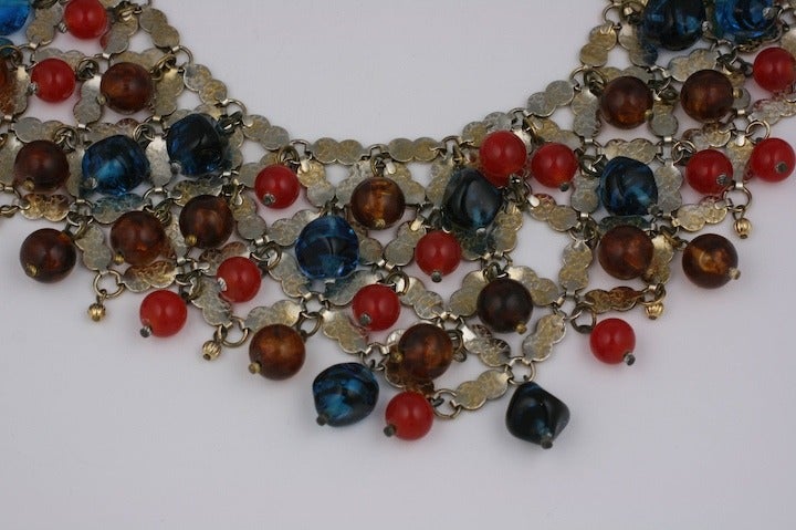 Countess Cis  large scale Mughal bib necklace 1950s. Composed of signature flat link gilt chain, bakelite resin and glass faux gemstone beads.
Many of her pieces are unsigned as is this item, but, her signature is apparent from the colors, scale