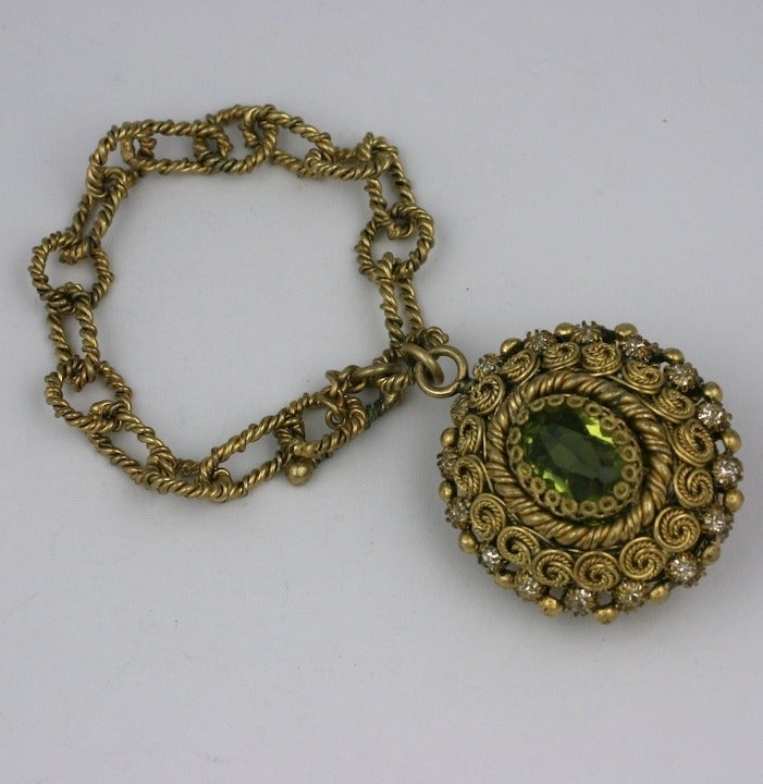 Rare Fob bracelet of peridot and pale citrine pastes set in gilt metal coil and wire work settings. Beautiful French quality by Countess Cis set in green gold finish. Large dimensional and reversible fob which is the same on both sides. France